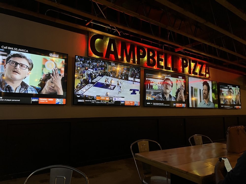 Campbell Pizza sign above five TVs